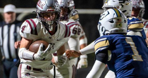 PHOTO BY FOREST WORGUM Montesano’s Zach Timmons (4) carries the football against the Seton Catholic defense during the Bulldogs’ 35-14 loss in a 1A State semifinal game on Saturday in Vancouver.