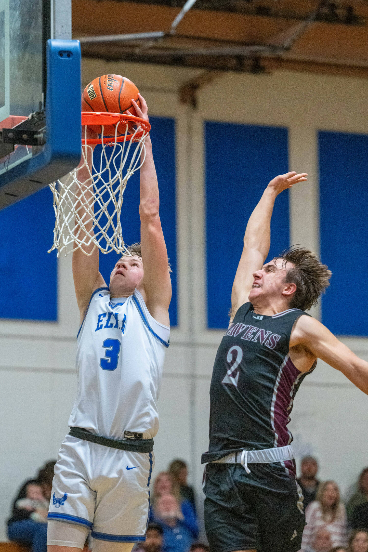 PHOTO BY FOREST WORGUM Elma’s Isaac McGaffey (3) dunks against Raymond-South Bend’s Chris Banker during the Eagles’ 67-62 victory on Friday in Elma.