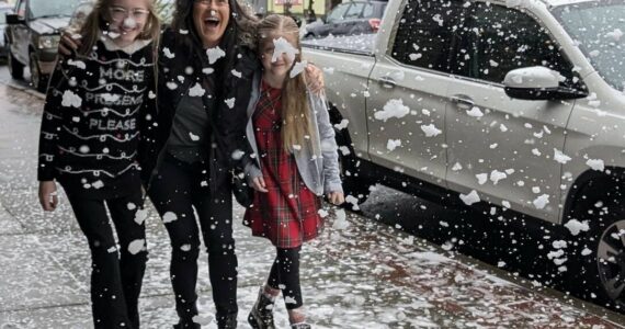 Wil Russoul
A trio enjoys a hint of snow at WinterFest on Saturday.