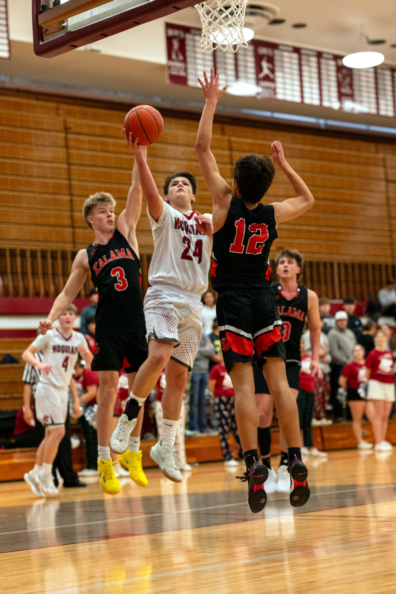 PHOTO BY FOREST WORGUM Hoquiam guard Lincoln Niemi (24) drives to the hoop against Kalama’s Henry Sigfridson (3) and Abel Koski (12) during the Grizzlies’ 65-49 win on Wednesday in Hoquiam.