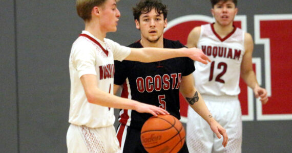 RYAN SPARKS | THE DAILY WORLD Ocosta’s Noah Prigmore defends Hoquiam’s Ryker Maxfield (left) during the Wildcats’ 55-39 victory on Thursday at Hoquiam Square Garden.