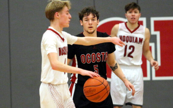 RYAN SPARKS | THE DAILY WORLD Ocosta’s Noah Prigmore defends Hoquiam’s Ryker Maxfield (left) during the Wildcats’ 55-39 victory on Thursday at Hoquiam Square Garden.