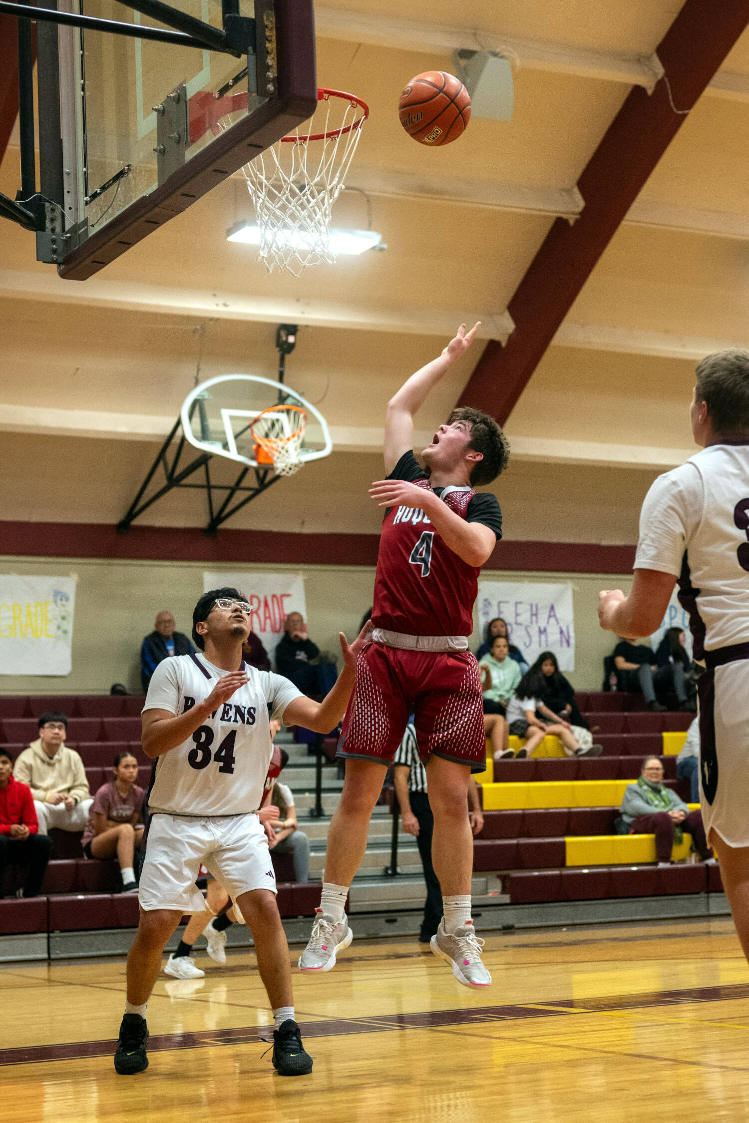 PHOTO BY FOREST WORGUM Hoquiam guard Joey Bozich (4) shoots over Raymond-South Bend’s Fernando Jiminez during the Grizzlies’ 57-44 win in the Raymond New Year’s Tournament on Saturday at South Bend High School.