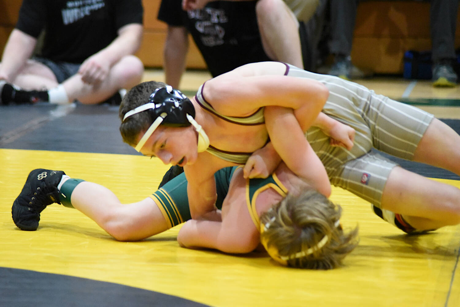 PHOTO BY SUE MICHALAK BUDSBERG Montesano freshman Finley Ekerson (top) works to pin Darrington’s Kinden Tollenaar during the 106-pound final of The Rock Tournament on Saturday at Vashon Island.