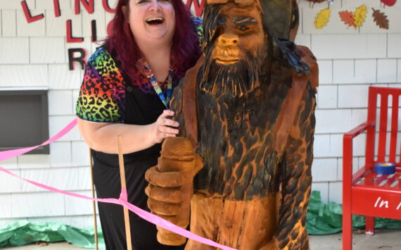 Jerry Knaak photos / The Daily World
Lincoln Elementary School 5th grade teacher Andrea Andrews poses for a photo with the Bigfoot sculpture commissioned by her father, Jim Andrews.