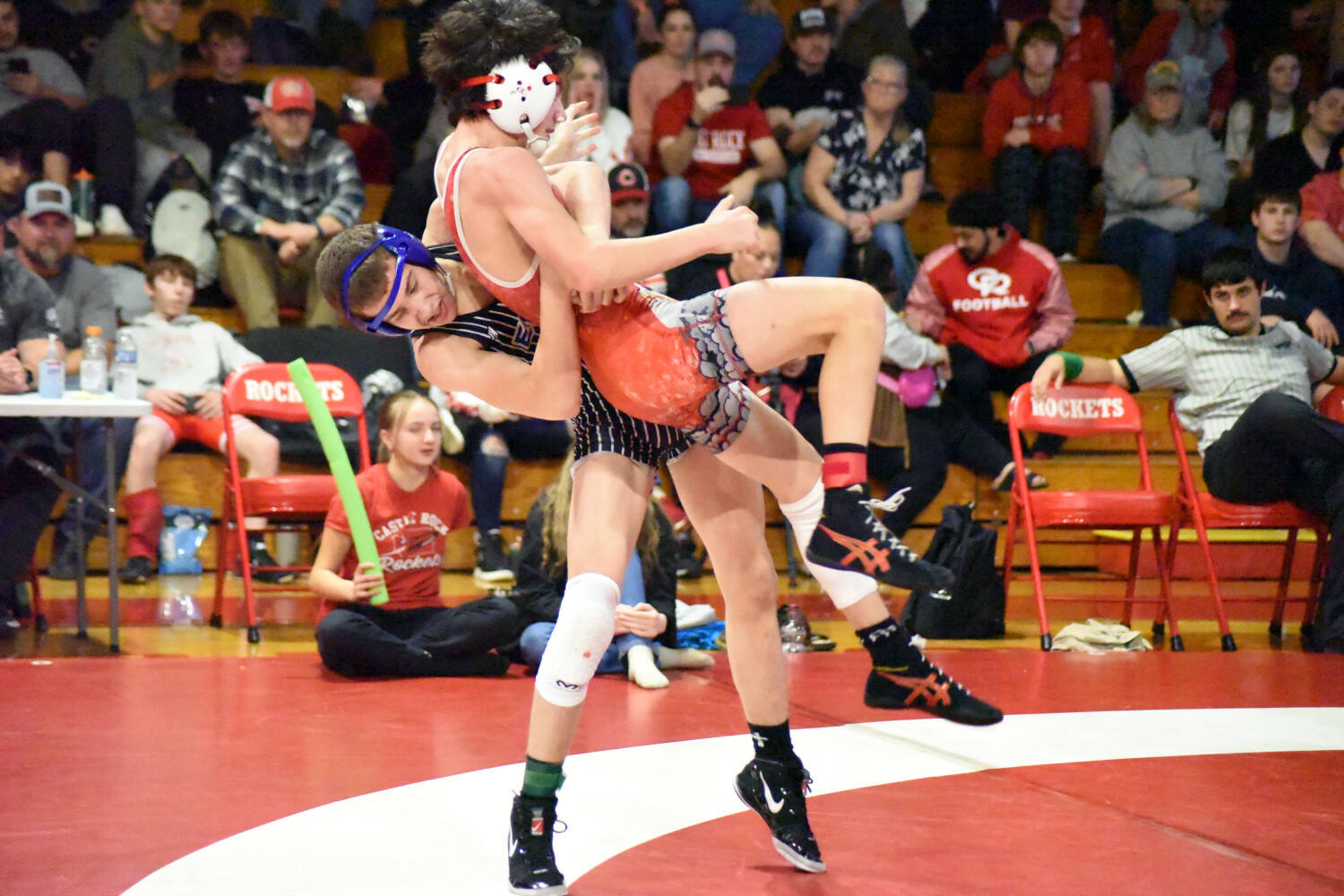 PHOTO BY SUE MICHALAK BUDSBERG Elma’s Aidyn Johnson (left) throws Castle Rock’s Kacen Hamilton in the 120-pound final of the Jim Bair Invitational on Saturday at Castle Rock High School.