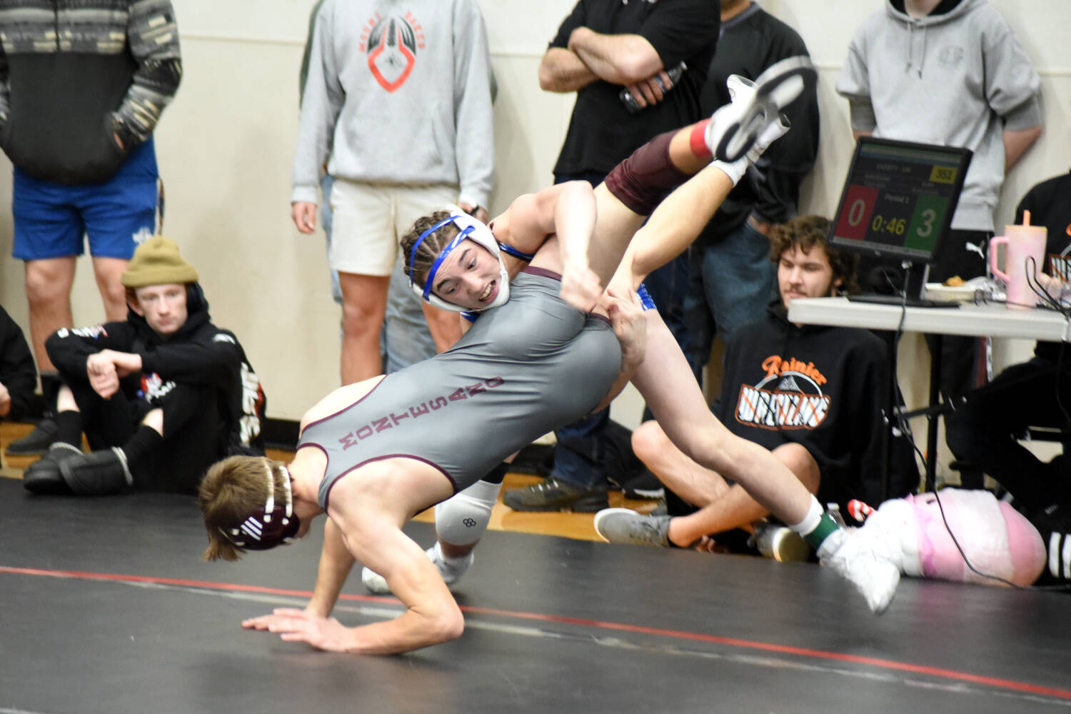 PHOTO BY SUE MICHALAK BUDSBERG Elma’s Blaize Salazar (top) works a double-leg takedown against Montesano’s Kole Kjesbu during the 144 pound first-place match at the Sgt. Justin Norton Memorial Invitational on Saturday at Rainier High School.