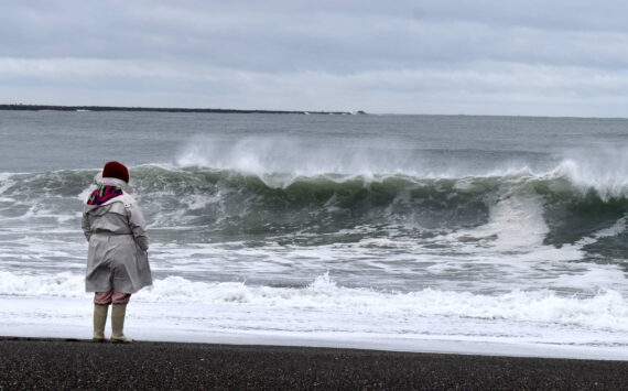 Photos Jerry Knaak / The Daily World
A spectator watches the king tide roll in at South Beach in Westport.