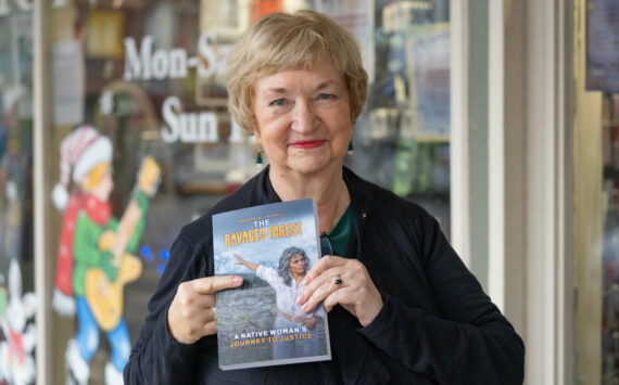 Kody Christen / The Chronicle
Author Sandy Crowell smiles for a photo with her new book “The Ravaged Forest” during an authors book signing event at Book ‘n’ Brush in Chehalis on Saturday, Dec. 21. The book is available on Amazon.