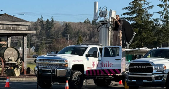 A technician assembles a temporary cell phone-receiving station in north county after an intense windstorm damaged one of the area’s primary towers, affecting service to thousands. (Jeff Clemens / Chinook Observer)