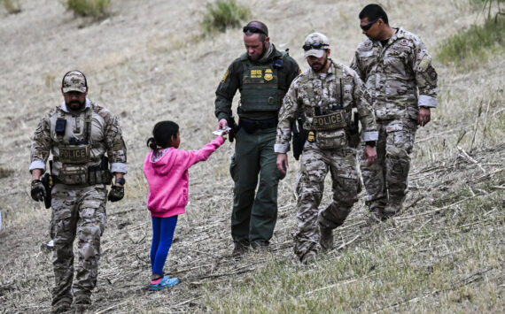 Chandan Khanna / AFP / Getty Images / TNS
A U.S. Customs and Border Protection officer gives food to an immigrant child waiting to be processed at a U.S. Border Patrol transit center after crossing the border from Mexico at Eagle Pass, Texas on Dec. 22, 2023.